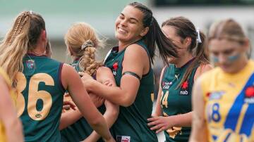 Tunisha Kikoak celebrates with Tasmania Devils teammates in a match against Western Jets at Prospect Park in 2022. Pictures by Phillip Biggs